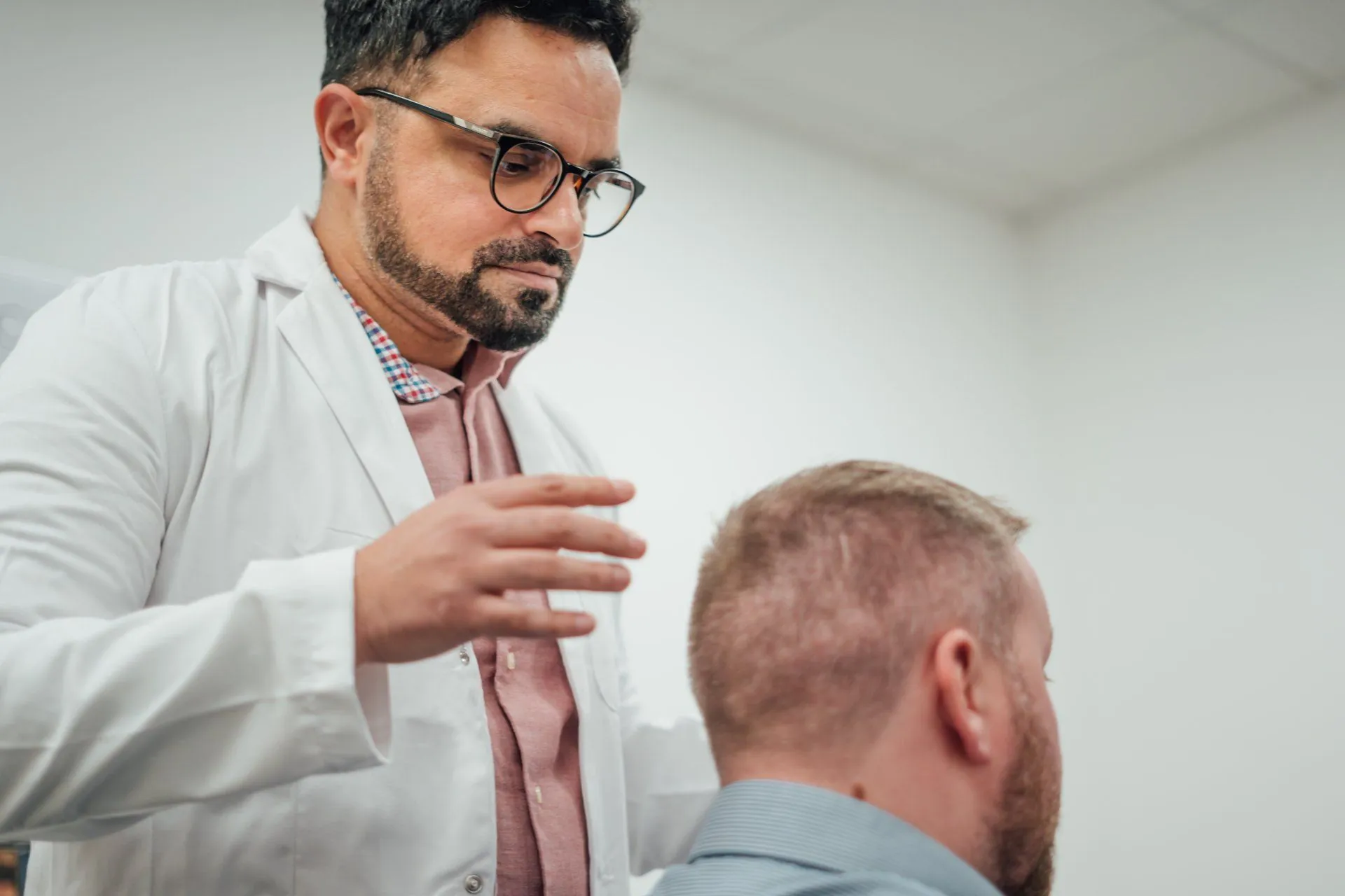 Dr Matee explaining a hairline plan to a patient