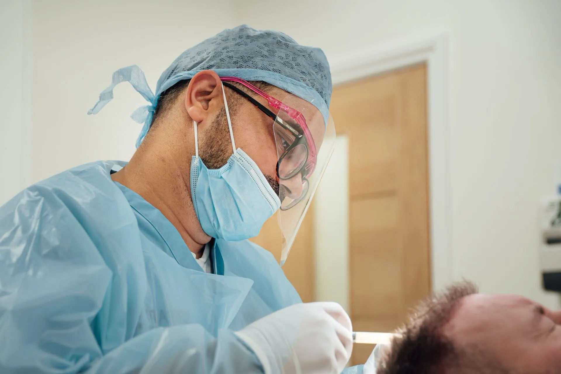 An FUE hair transplant procedure in progress